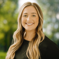 professional headshot of Jessica. She is smiling, has long blonde wavy hair and is looking at the camera.